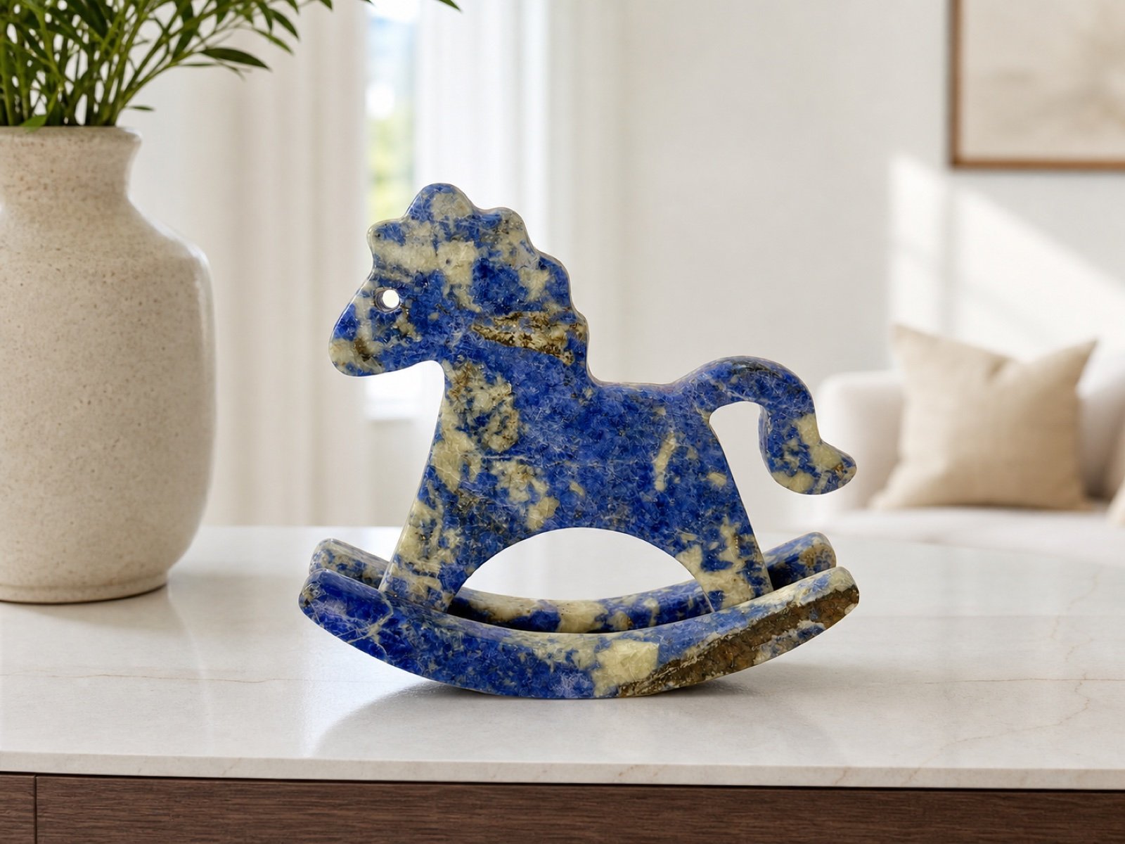 Blue Rocking Horse in a styled natural stone interior
