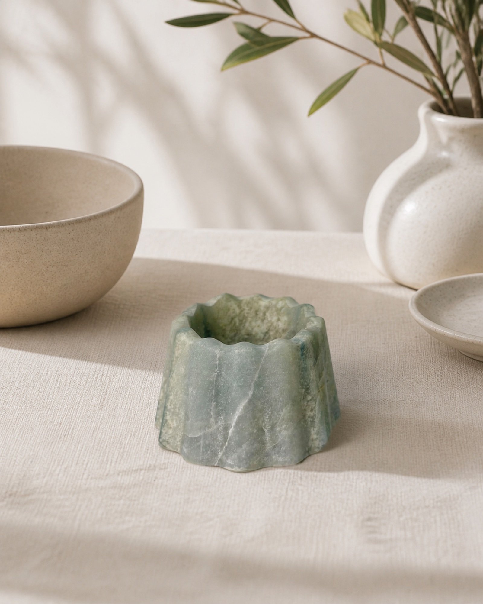 Green Fluted Bowl in a styled natural stone interior