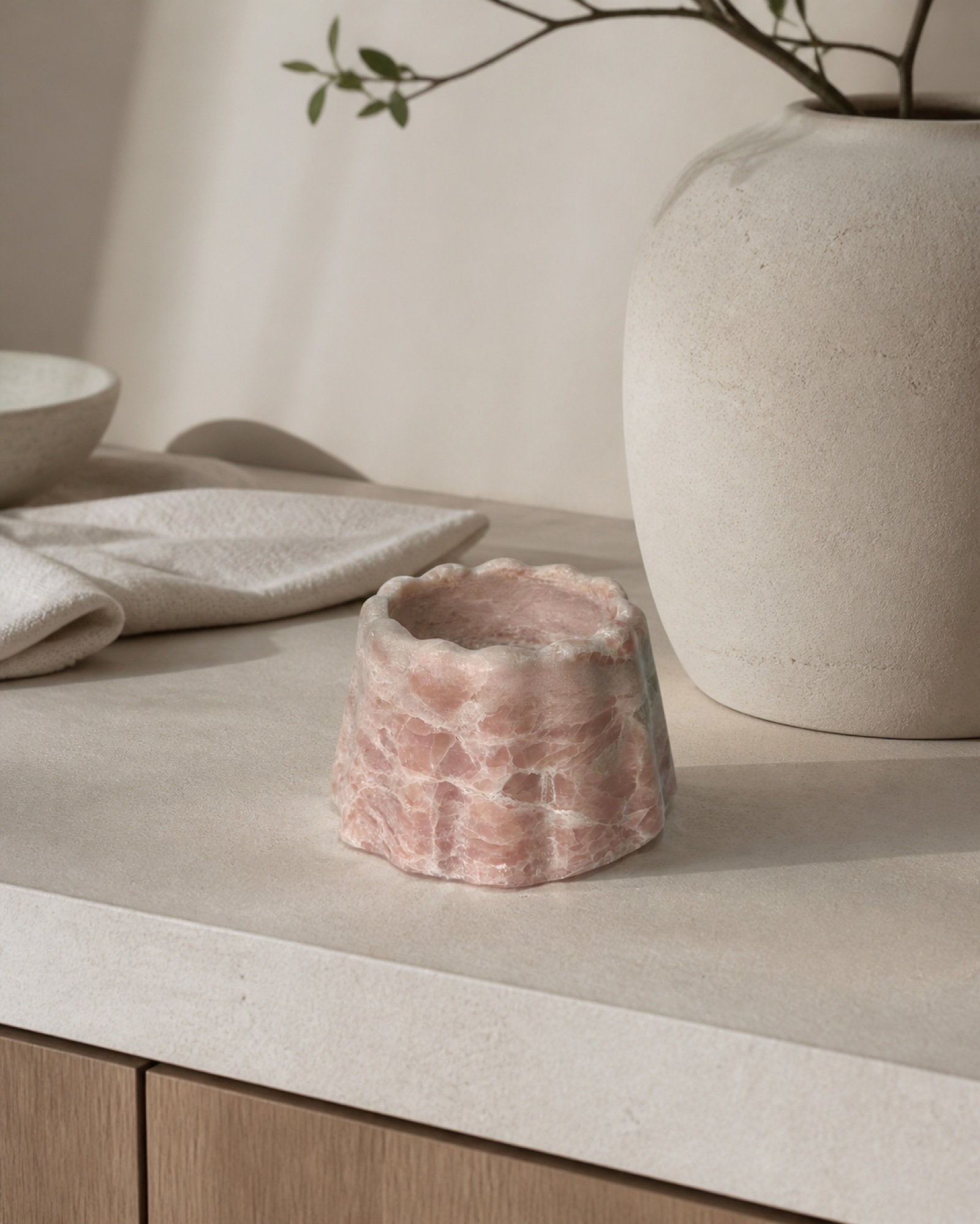 Pink Small Stone Base in a styled natural stone interior